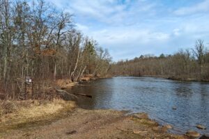 Wooded buildable land near the Namekagon River in Trego, Wisconsin with rolling terrain, utilities, and private forest setting