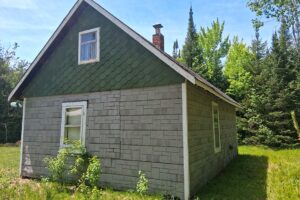 Somo River waterfront property near Tomahawk & Tripoli, WI. Includes cabin, well, septic, and electric. Nearly 400 ft frontage